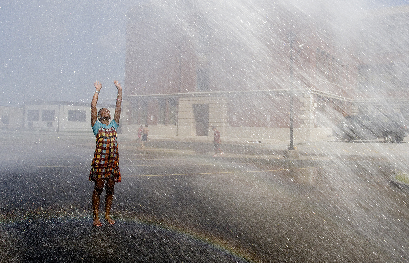 Ajanee Mohammed, 11, of Rochester, cool off in the spray from an open fire hydrant at School 41 on Ridge Road. The city opened hydrants and spray parks across the city to help residents cool off on a hot day. (staff photo by Jeffrey Blackwell)  (staff photo by Jeffrey Blackwell)